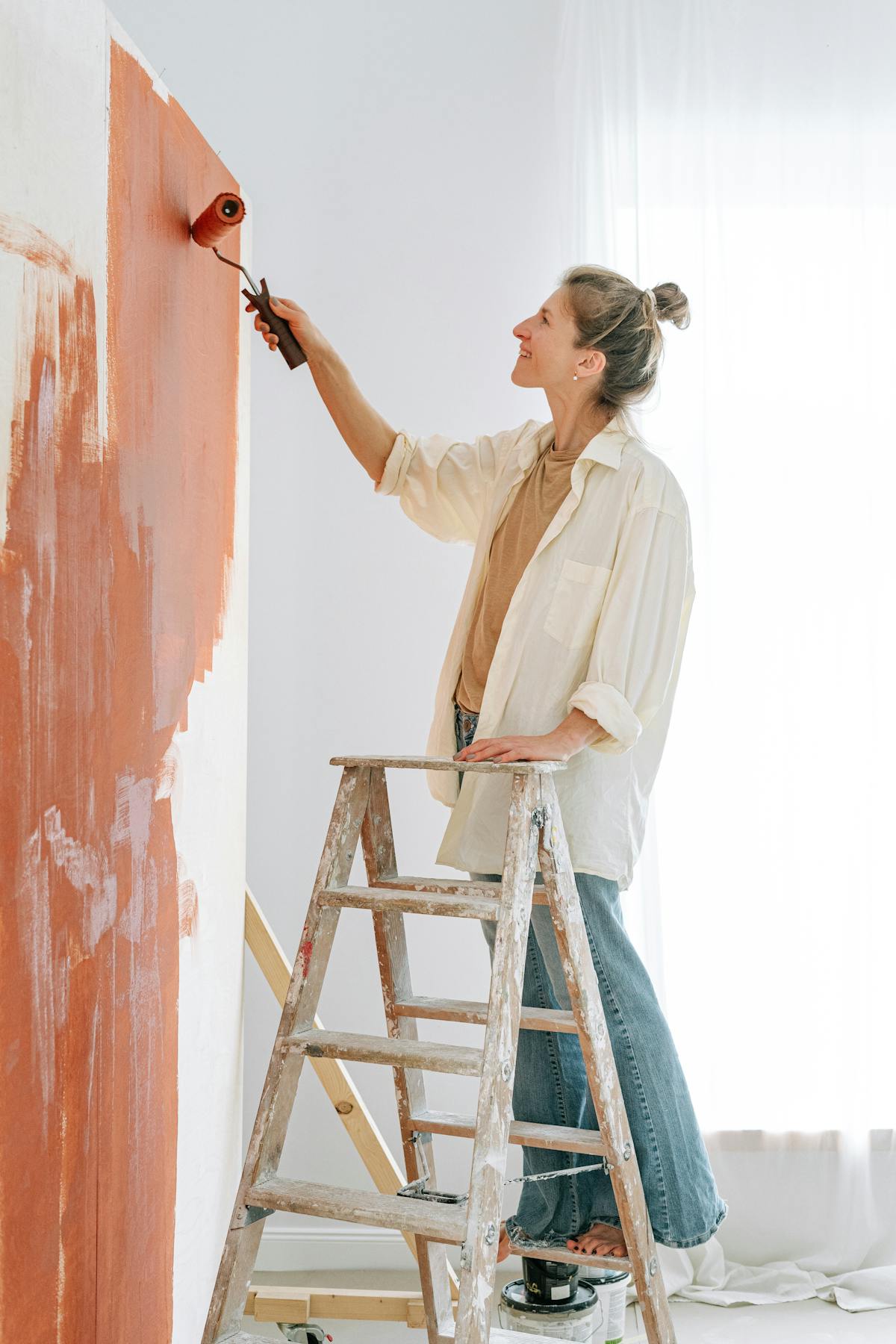Professional painter applying paint to an interior wall